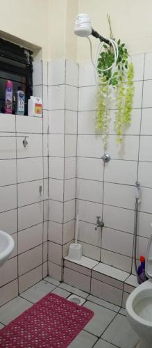 a bathroom with a shower with a sink and a toilet at Studio Apartment near the Airport in Nairobi