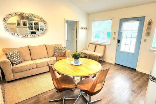 a living room with a table and a couch at Cottage lake view with Deck and BBQ Grill in Three Mile Bay