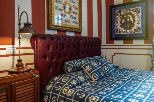 a bedroom with a bed with a red head board at Regal House Anzio Terrazzo in Anzio