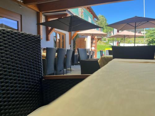 a table and chairs with umbrellas on a patio at Rebenlandhof in Leutschach
