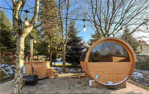 a large wooden mirror sitting next to a tree at Stunning Home In Perlino With Sauna in Perlino