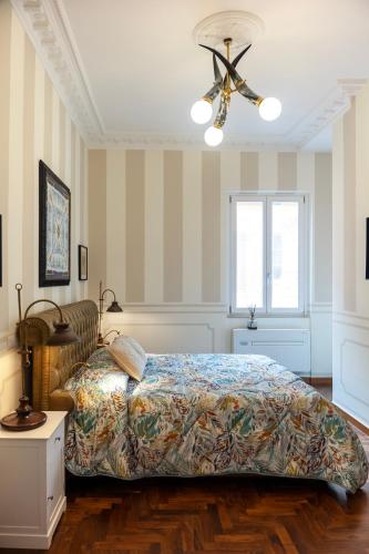 a bedroom with a bed and a ceiling fan at Regal House Anzio Terrazzo in Anzio