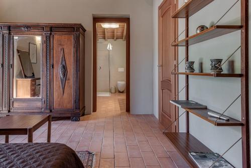 a room with a bed and a wooden cabinet at comfortable private villa with pool San Giuseppe Tramontana in Montecatini Val di Cecina