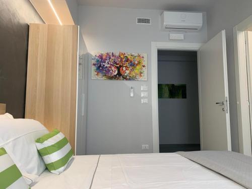 a bedroom with a bed and a painting on the wall at Casa Armonia Apartment Sulmona in Sulmona