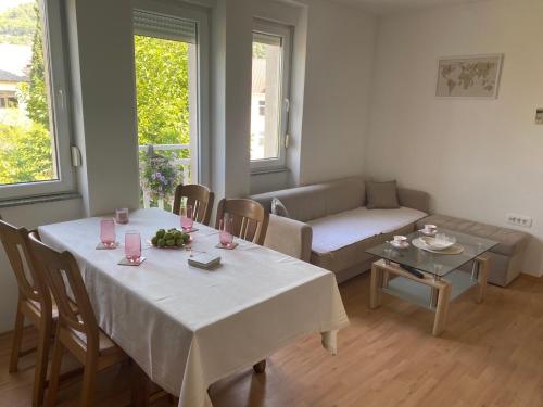 a living room with two tables and a couch at Apartment Karizma Mostar in Rodoč