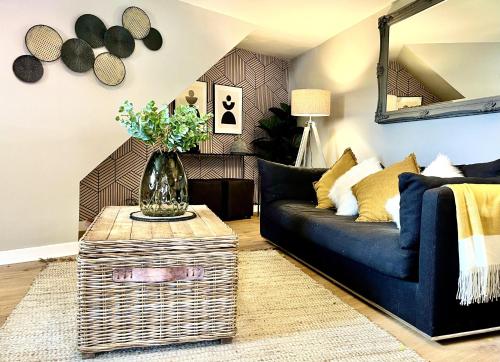 a living room with a blue couch and a table at Sleeps 2 -Central Ellesmere -Parking - PetFriendly in Ellesmere
