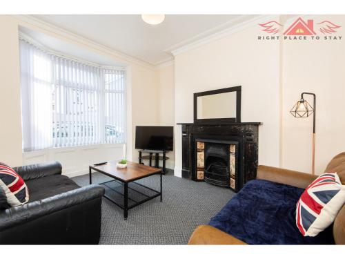a living room with a couch and a fireplace at Darlington Modern 2 Bed Apartment Great for Contractors in Darlington