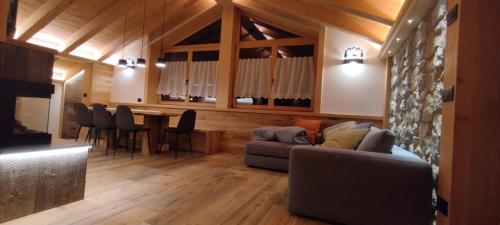 a living room with a couch and a table and chairs at Chalet Matilde in Padola