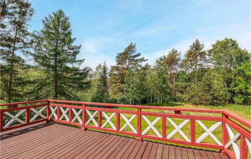 a red wooden bridge with trees in the background at 3 Bedroom Awesome Home In Legbad in Legbąd