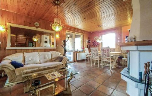a living room with a couch and a table at 3 Bedroom Awesome Home In Legbad in Legbąd
