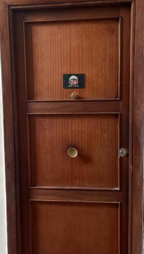 a wooden cabinet with a door with a drawer at B&B leperle in Torre del Greco