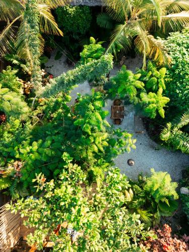 a model of a garden with palm trees and plants at The Garten Living in Paje
