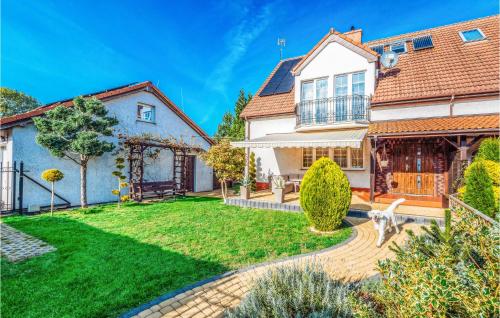 a large white house with a yard at 5 Bedroom Stunning Home In Grzybowo in Grzybowo