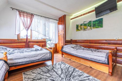 Postel nebo postele na pokoji v ubytování Dom Wypoczynkowy Wierchy