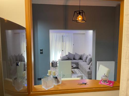 a mirror reflection of a living room with a couch at Maria's luxury apartment in Athens