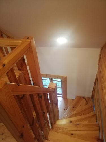 a room with wooden stairs in a house at Chatka Na Rozdrożu in Uście Gorlickie