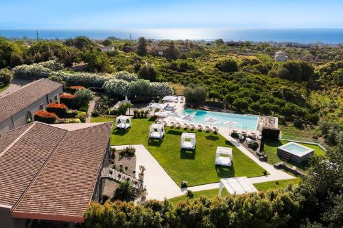 an aerial view of a house with a yard with a pool at Kepos Etna Relais & Exclusive Spa in Santa Venerina