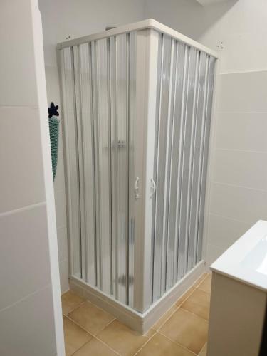 a shower stall in a bathroom with white walls at Apartamento en el Parque in Ontinyent