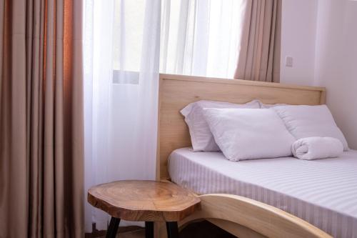 a small bedroom with a bed and a table at Studio Apartment near the Airport in Nairobi