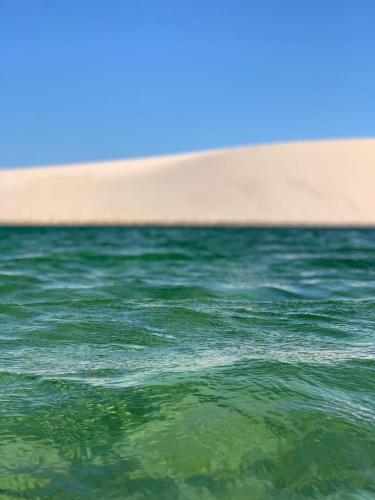a body of water with a beach in the background at Amaro Residence in Santo Amaro