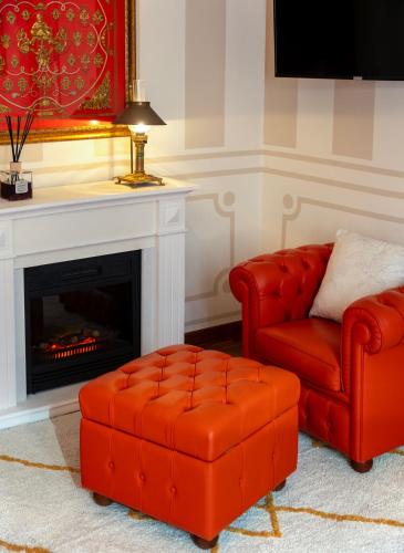 a living room with a couch and a chair and a fireplace at Regal House Anzio Terrazzo in Anzio