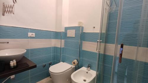 a bathroom with a toilet and a sink and a shower at Hotel Canarco in Viareggio
