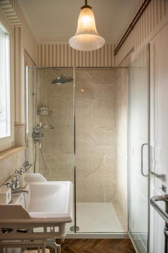 a bathroom with a glass shower and a sink at Regal House Anzio Terrazzo in Anzio