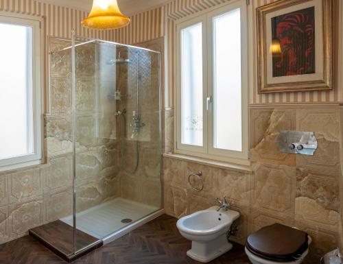 a bathroom with a shower and a toilet and a sink at Regal House Anzio Terrazzo in Anzio