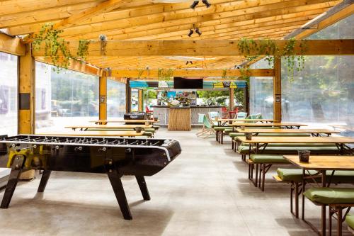 a restaurant with a ping pong table in the middle at JO&JOE Hossegor in Hossegor