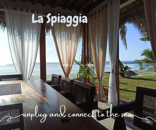 a table and chairs with a view of the ocean at La Spiaggia, tropical villa with private beach in Sainte Marie