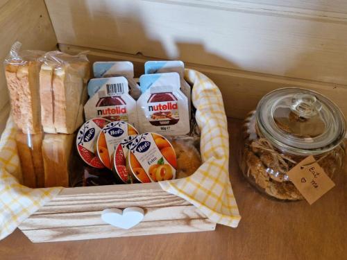 ein Korb mit verschiedenen Lebensmitteln auf einem Tisch in der Unterkunft Corte Dioniso Eco Apartments & Suites in Crispiano