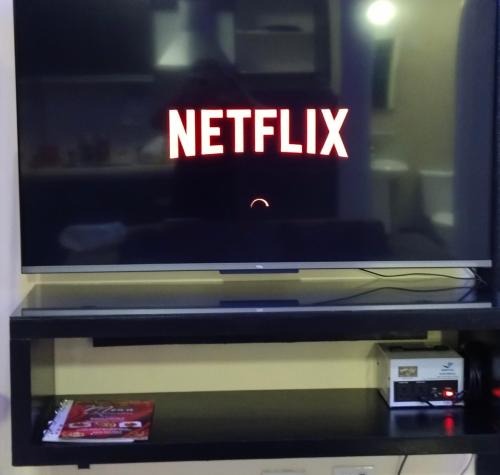 a tv sitting on top of a table at Jack Kandi Grosvenor Square in Angeles