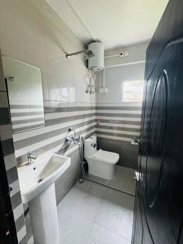 a bathroom with a sink and a toilet at Hill inn homestay in Sukhia Pokhari