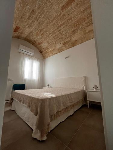 a bedroom with a bed in a white room at Casa Paiano in Alezio