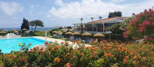 a resort with a swimming pool and some flowers at 135 Beach Villa in Porches