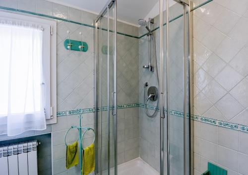 a shower with a glass door in a bathroom at Agriturismo Le Girandole in Diano Marina