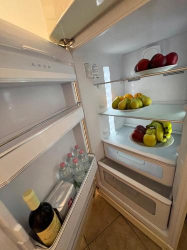 an open refrigerator filled with lots of fruits and vegetables at Ortigia_corte d'avolio in Siracusa