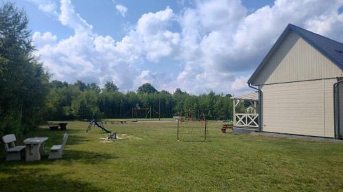 a park with a playground and a building at Brzozowa Polana in Perlino