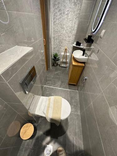 a bathroom with a toilet and a sink at 2k Cozy Beach House in Neoi Epivates