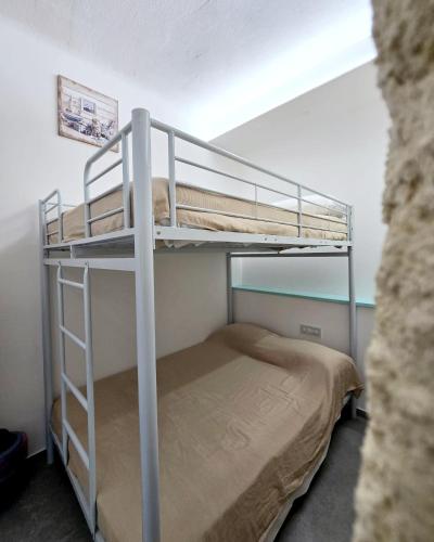 a bunk bed in a small room with a bunk bedutenewayangering at Aquamarina Rooms in Porto Cesareo