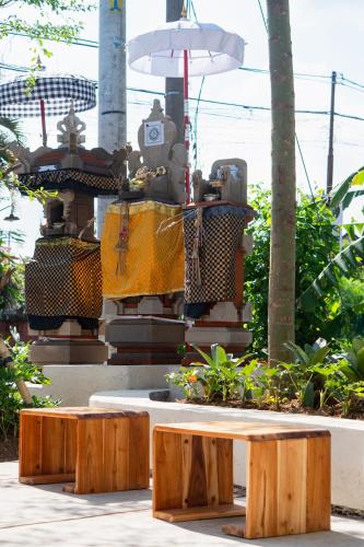a wooden bench and a table in a park at Tut Winten a Tranquil Living Villa Ubud in Ubud