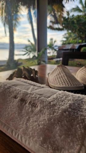 a table with a bed with a view of the ocean at La Spiaggia, tropical villa with private beach in Sainte Marie