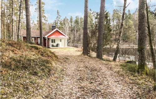 a house in the woods next to a dirt road at 2 Bedroom Awesome Home In Frövi in Frövi