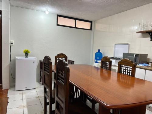 a dining room with a wooden table and chairs at Apartment in the city - 2 Bedrooms 2 Bath in Baños