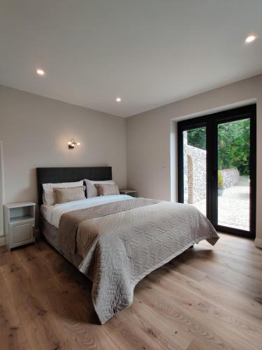a bedroom with a large bed and a large window at Moynure House Boutique B&B & Separate Two bedroom Chalet in Athlone