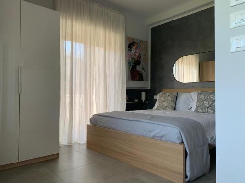 a bedroom with a bed and a large window at Casa Armonia Apartment Sulmona in Sulmona