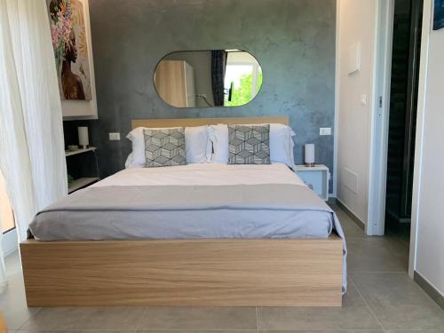 a bedroom with a large bed with a large mirror at Casa Armonia Apartment Sulmona in Sulmona