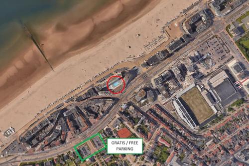 an overhead view of a beach with a red sign at Cozy studio with pool close to the sea in Ostend