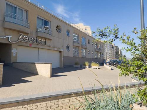 a building with a sign on the side of it at Cozy studio with pool close to the sea in Ostend