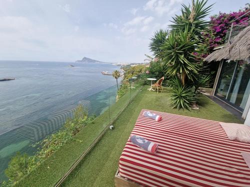 a bench on the side of a house overlooking the ocean at Condesa del Mar adults only in Altea